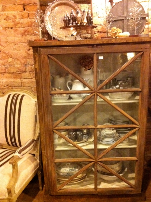 Shelves with antique window door & incred chair!